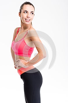 Attractive cheerful fitness girl in pink top and black leggings