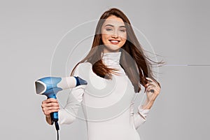 attractive cheerful lady drying strong healthy hair