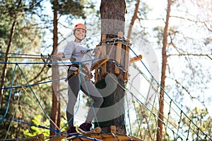 Attractive cheerful woman having a break on her rope way