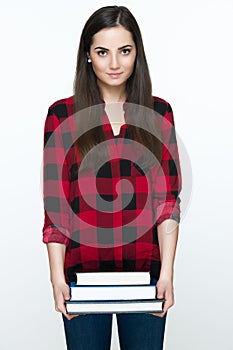 Attractive cheerful young female student holding books, isolated on white background.