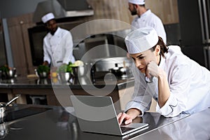 attractive chef using laptop