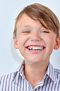 Attractive child boy with perfect toothy smile smiling laughing posing at camera