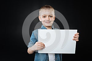 Attractive child posing with sheet of paper
