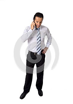 Attractive confident senior Hispanic businessman at work talking business on mobile phone standing