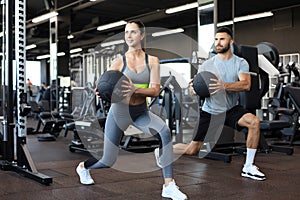 Attractive couple doing fitness with medcine ball at gym photo