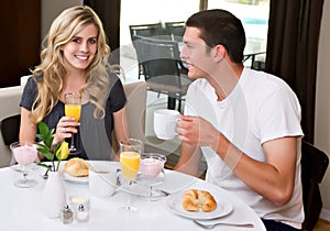 Attractive couple eats breakfast