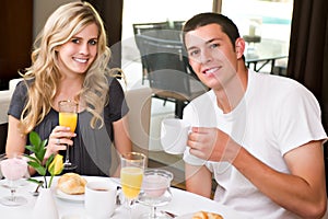 Attractive couple eats breakfast