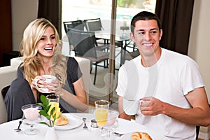 Attractive couple eats breakfast