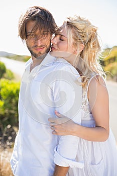 Attractive couple embracing by the road