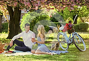 Attractive Couple Enjoying Romantic Sunset Picnic in Countryside. Romance concept. Inspiring feelings. Cheers. Celebrate