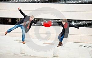 Attractive couple fighting over a love heart pillow