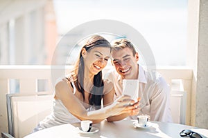 Attractive couple having first date.Coffee with a friend.Smiling happy people making a selfie.Sharing on social media