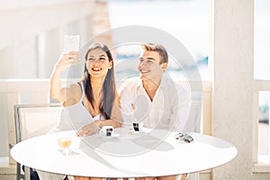 Attractive couple having first date.Coffee with a friend.Smiling happy people making a selfie with a smartphone