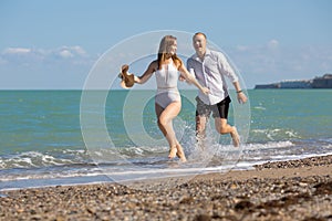 Attractive couple having fun at the sea