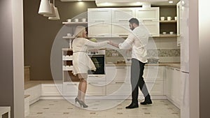 Attractive Couple Having Fun Together Dancing In The Kitchen