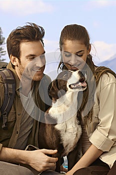 Attractive couple hiking with dog