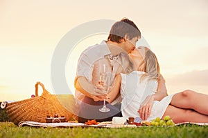 Attractive couple kissing on romantic picnic