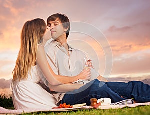 Attractive couple kissing on romantic picnic