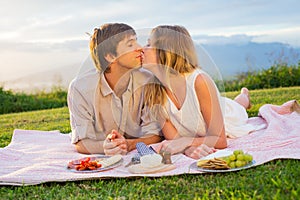 Attractive couple kissing on romantic picnic