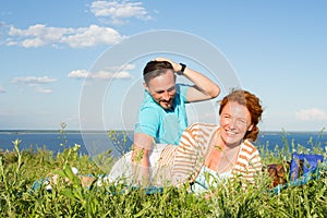 Attractive couple in love having fun and enjoying the beautiful nature and blue skies with clouds. Smiled and happy couple