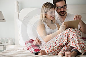 Attractive couple in love using digital tablet