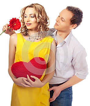 Attractive couple of lovers. Man presents flower.