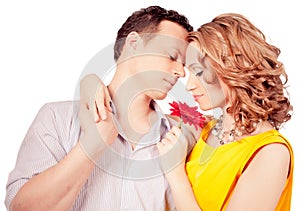 Attractive couple of lovers. Man presents flower.