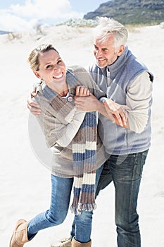 Attractive couple messing about on the beach