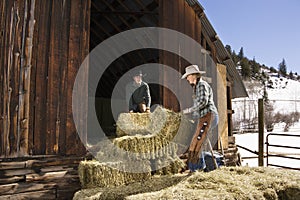 Attractive Couple Moving Hay Bales