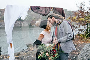 Attractive couple newlyweds laugh and smile happy and joyful moment. Autumn wedding ceremony outdoors. Stylish bride and