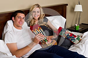 Attractive couple opening Christmas gifts