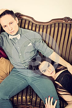 Attractive couple, pair of lovers at ancient living room sitting