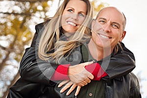 Attractive Couple in Park with Leather Jackets