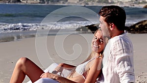 Attractive couple relaxing on the beach