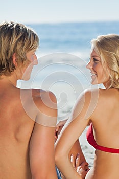 Attractive couple relaxing on the beach together