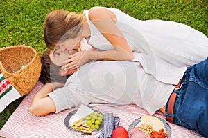 Attractive couple on romantic afternoon picnic kissing