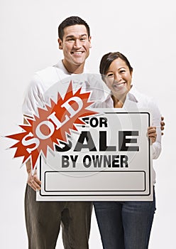 Attractive couple with sold sign