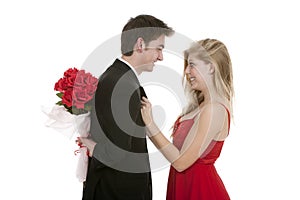 Attractive couple together with bouquet of roses