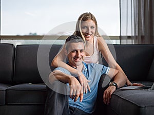 Attractive Couple Using A Laptop on couch