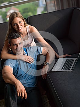 Attractive Couple Using A Laptop on couch