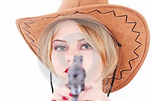 Attractive cowboy woman aiming a gun