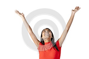 Attractive dark-haired smiling Latina woman with arms outstretched and looking up on a pure white background. Studio photography