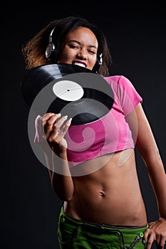 Attractive deejay in headphones biting vinyl