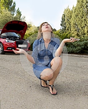 Attractive desperate and confused woman stranded on roadside with broken car engine failure crash accident calling on mobile phone