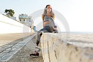 Attractive disabled athlete woman with prosthetic leg