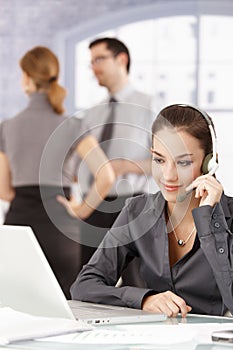 Attractive dispatcher talking on headphones