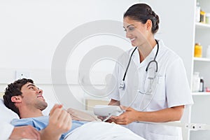 Attractive doctor taking the blood pressure of a patient