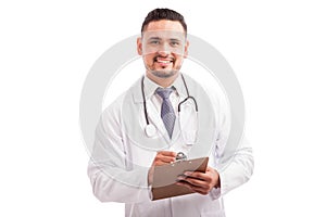 Attractive doctor writing a prescription
