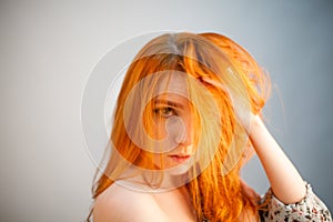 Attractive dreammy portrait of redhead woman in soft focus