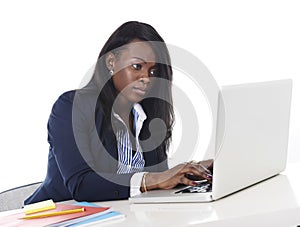 Attractive and efficient black ethnicity woman sitting at office computer laptop desk typing